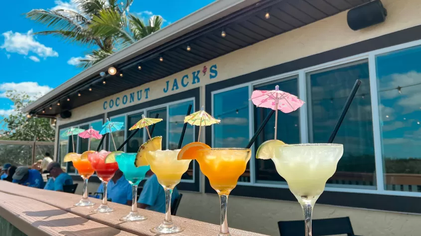 A line-up of frozen drinks on a ledge outside