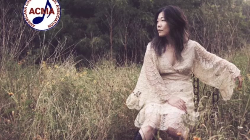 Betty Soo in a field; ACMA logo in corner