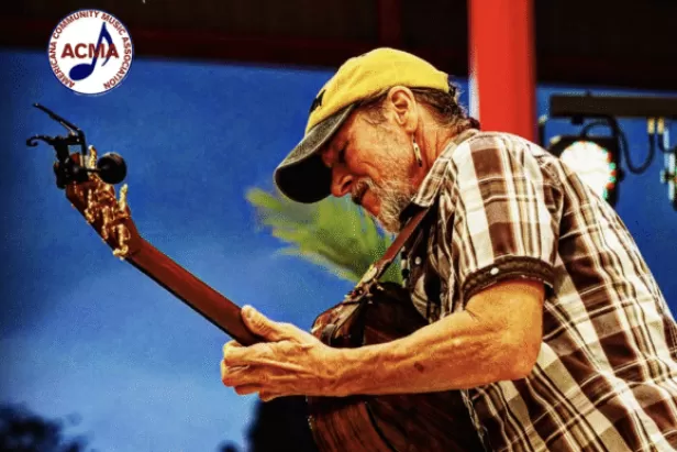 profile view of guitarist Brian Smalley performing
